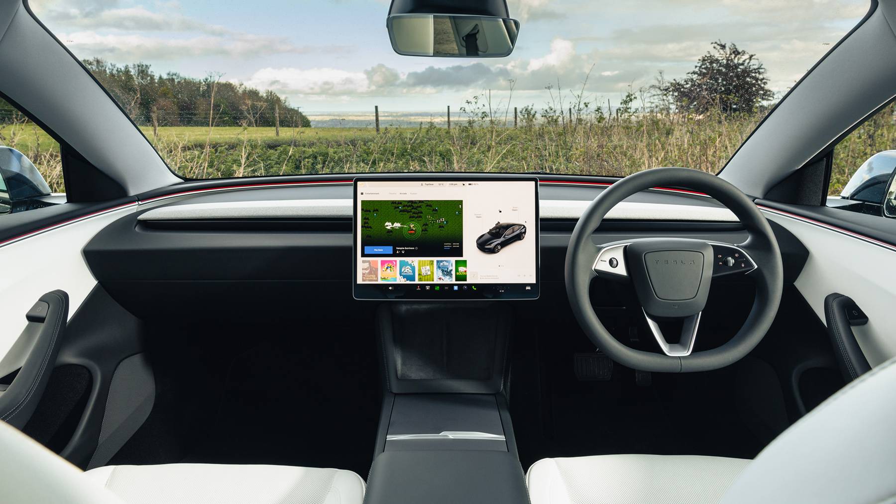 Interior shot of a sleek car with a driver holding the steering wheel, featuring a digital display and modern dashboard controls.