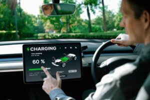 A car's dashboard displays a charging screen showing a 60% charge with a remaining time of 6 hours and 10 minutes.
